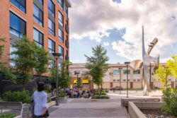 courtyard of an apartment complex with a large sculpture.